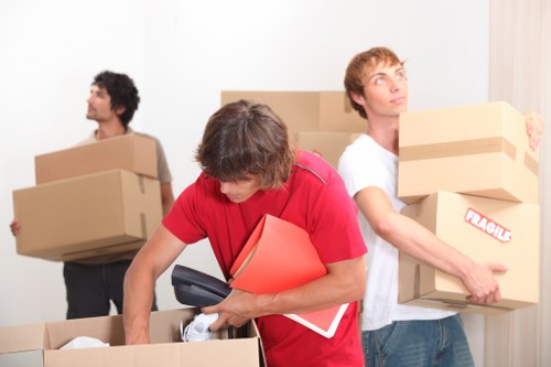 Professional movers planning access on a residential Keston street